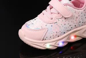 Detailed view of pink LED sneakers for girls featuring cherry blossom patterns and velcro