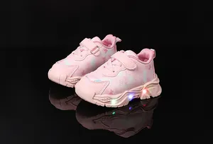 Detail of girls' butterfly sneakers showing LED light-up soles and velcro strap