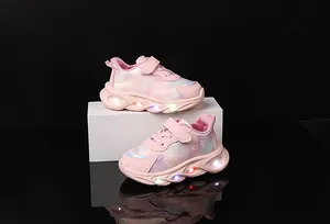 Detail of pink LED light-up girls' sneakers with heart prints and velcro straps