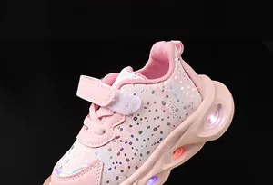 Detail of pink girls' LED sneaker showing floral patterns and vibrant light-up soles