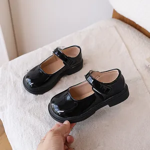 Classic black patent leather Mary Jane shoes for girls with velcro strap and chunky sole