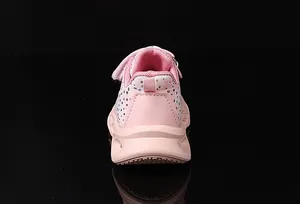 Rear view of pink girls sneakers featuring silver polka dots and thick wavy soles