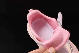 Detailed macro of pink mesh lining and breathable insole of kids' fashion sneakers