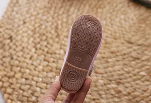 Detailansicht der rutschfesten Gummisohle eines rosa Kinderschuhs in der Größe 23 mit Logo