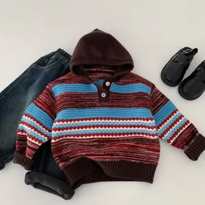 Detailed close-up of a striped hooded knit sweater with colorful patterns and button collar