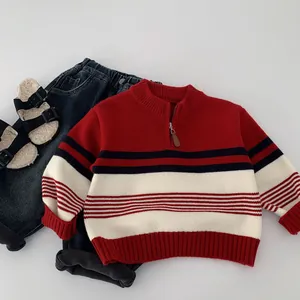 Close-up of children's striped knit sweater with neck zipper and ribbed cuffs