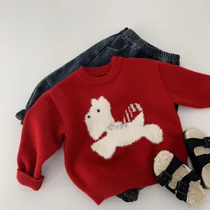 Flat lay detail of red knit sweater with white puppy appliqué and navy denim jeans
