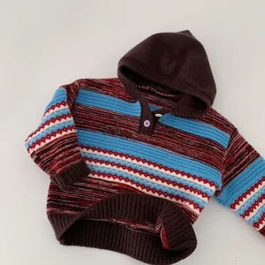 Detail of hooded striped kids sweater showing textured knit and purple button closure
