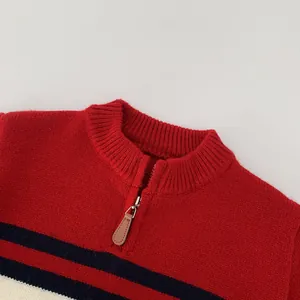Detail of red and navy striped knit sweater showing high collar and leather zipper pull