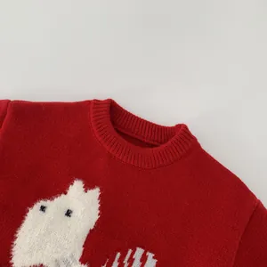 Close-up of red ribbed neckline and fuzzy white Moomin character on a knitted sweater