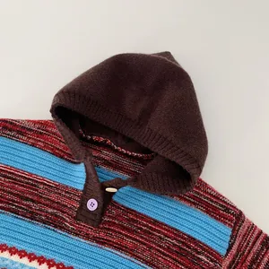 Detail view of colorful striped knit sweater with hood and two round buttons for kids