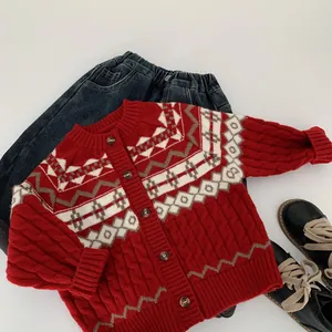 Flat lay of red knit cardigan with Fair Isle patterns, denim jeans and black shoes