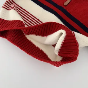 Children's striped knit sweater with red, white, and navy panels and collar zipper