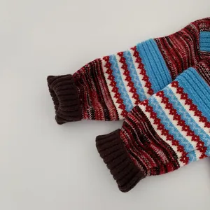 Detailed close-up of striped knitted sweater sleeve with brown ribbed cuffs for kids