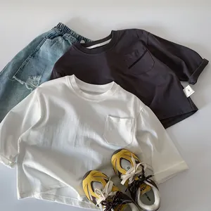 Flat lay detail of kids' long sleeve t-shirts paired with ripped denim shorts and sneakers