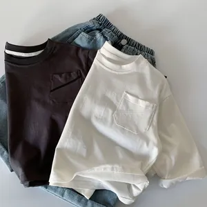 Flat lay of cotton t-shirts in grey and white with washed blue denim shorts set