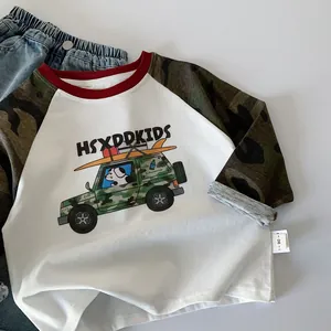 Close-up of kids' raglan t-shirt with camo sleeves and cartoon dog driving an off-road car