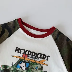 Detail of kids long sleeve shirt with camouflage raglan sleeves and cartoon car print