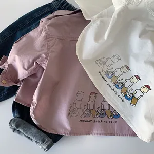 Flat lay of cotton shirts with cartoon illustration and dark blue denim jeans
