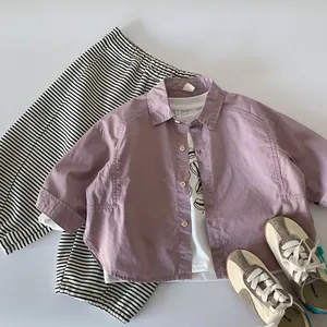 Flat lay of boys lavender shirt, cartoon t-shirt, and striped trousers toddler set