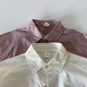 Detailed macro view of cotton kids shirts with soft texture and wooden button closure