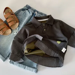 Detail of boys' polo shirt set with faux two-piece design, denim shorts, and sandals