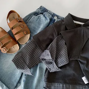 Flat lay of boys' grey faux two-piece polo shirt with blue denim jeans and sandals