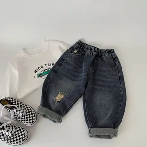 Toddler casual outfit set featuring a white long sleeve tee and distressed denim jeans