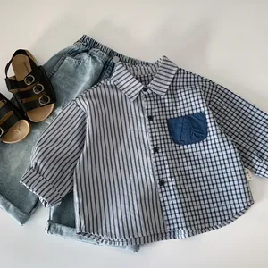 Detail of boys' spliced shirt with stripes and checks, blue jeans and leather sandals