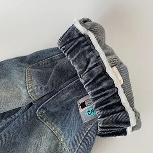 Boys elastic waist jeans in medium blue wash with cartoon patch and yellow stitching