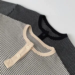 Detail of boys' striped cotton Henley shirts with two-button collar and ribbed neckline