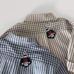 Striped cotton boys shirt with vintage embroidery patch in light blue and beige colors