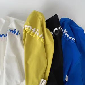Detail of creative foam print and labels on kids' cotton long sleeve t-shirts