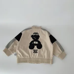 Kids baseball jacket featuring a beige color block design and a large bear silhouette on the back