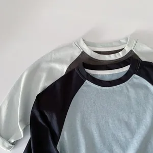 Detail of reinforced crew neck and neat stitching on boys cotton raglan sleeve shirts