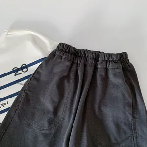 Detail of boys striped polo t-shirt with number 26 and charcoal gray knit cotton shorts
