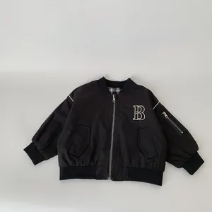 Boys reversible black flight jacket with embroidered B letter and check lining detail