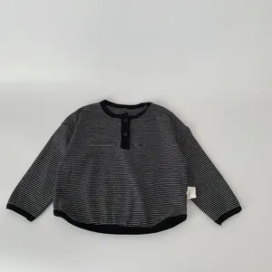 Classic black and white striped long sleeve kids T-shirt with a buttoned Henley neck