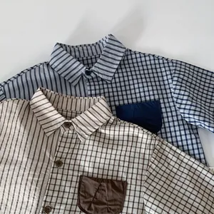 Detail of boys' patchwork cotton shirt showing contrast stripes and plaid textures