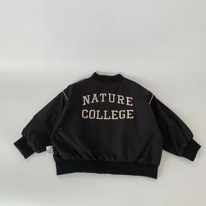 Kids black reversible baseball jacket featuring Nature College embroidery on back