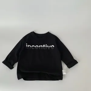 Close-up of boys black long sleeve cotton T-shirt with white and black incentive print
