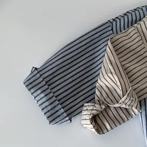 Detailed view of striped cotton shirts showing fabric texture and folded cuff craftsmanship