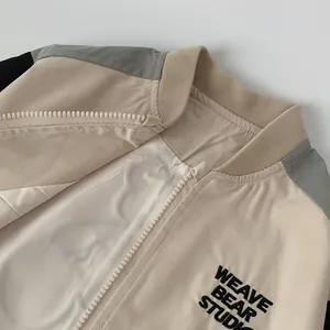 Detail showing the ribbed collar and printed bear studio lettering on kids' jacket