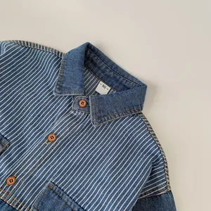 Detail of striped denim shirt with contrast yellow stitching and brown resin buttons