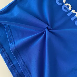 Detail of blue cotton boy T-shirt showing high-density knit fabric and 3D printed letters