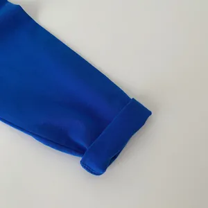 Detailed view of royal blue cotton long-sleeve cuff with premium rolled edge texture