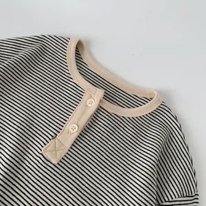 Detail of boys striped cotton long sleeve tee with beige collar and two-button placket