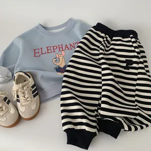 Detail of kids spring set with blue elephant sweatshirt and striped jogger pants