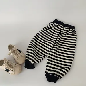 Classic black and white striped joggers for boys featuring elastic waistband and cuffs
