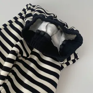 Detail of high-elastic wide waistband and stripes on kids cotton jogger pants
